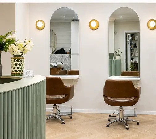 Arched mirrors and tan leather styling chairs